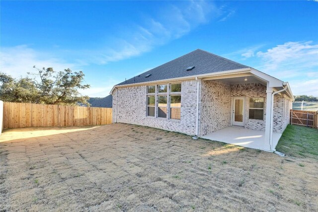 1429 Cole Estates Dr, Georgetown, TX 78628 - rear view of house featuring a fenced backyard, a patio area, and brick siding