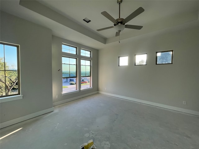 spare room with a water view and ceiling fan