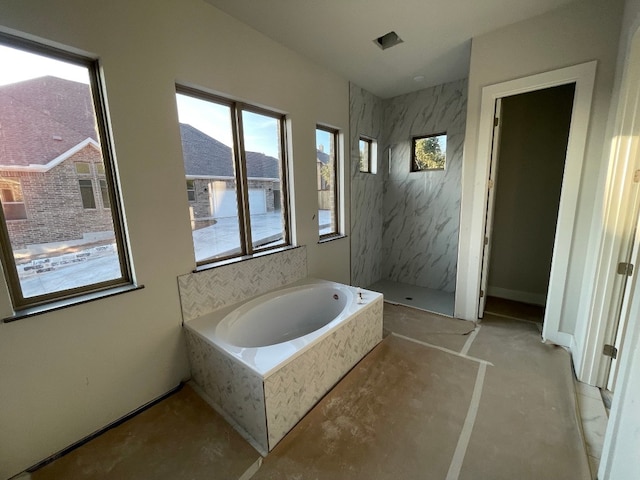 bathroom featuring independent shower and bath