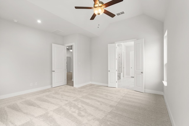 unfurnished bedroom with ceiling fan, lofted ceiling, and light colored carpet