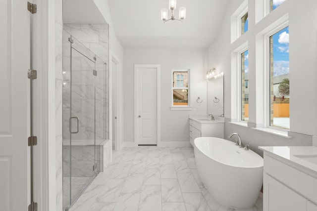 bathroom with vanity, independent shower and bath, and a chandelier