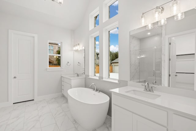 bathroom with vaulted ceiling, vanity, separate shower and tub, and a wealth of natural light