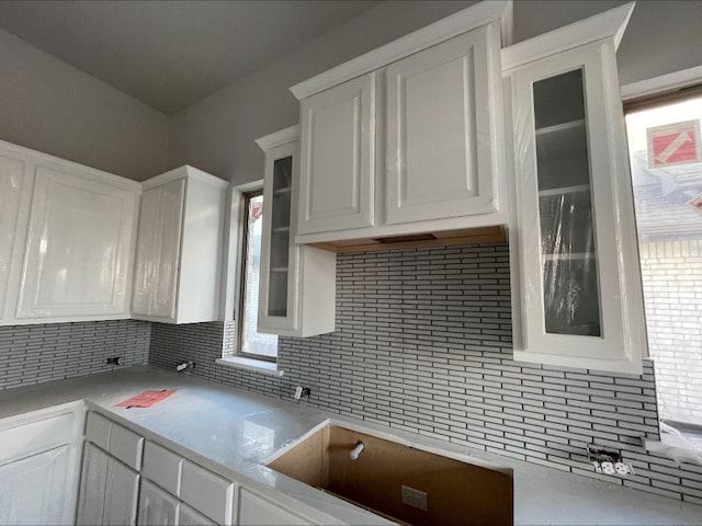 kitchen with white cabinets and decorative backsplash