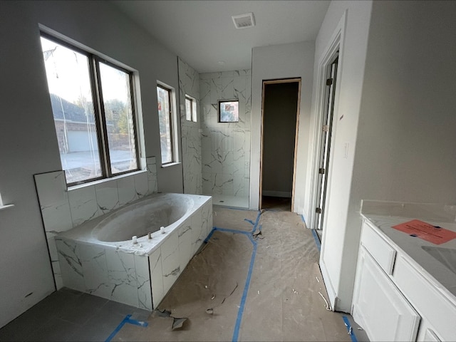 bathroom featuring vanity and shower with separate bathtub