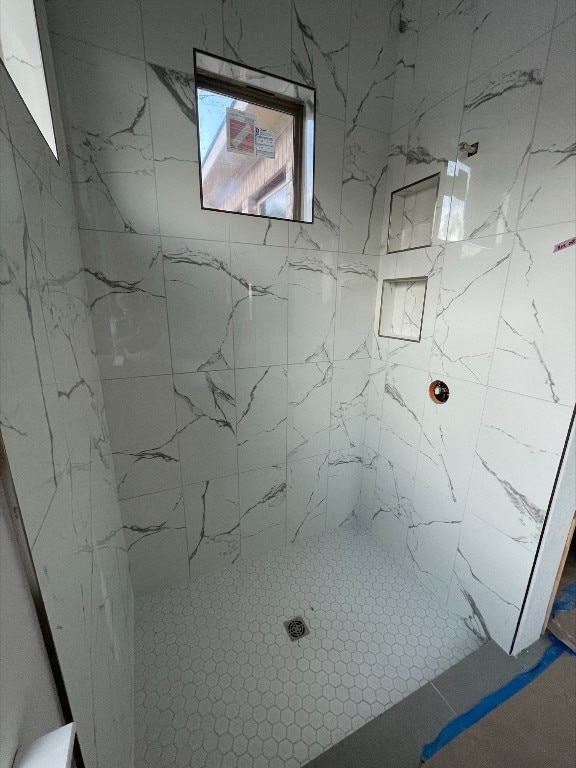 bathroom with a tile shower