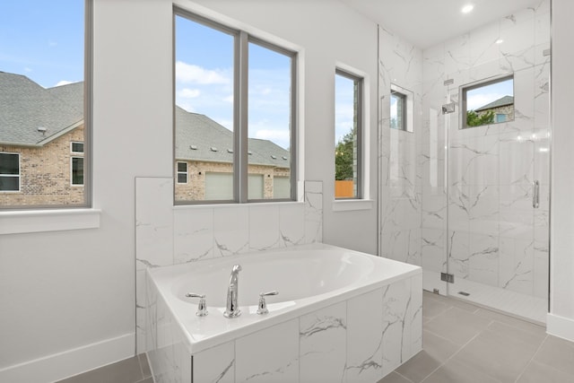 bathroom featuring tile patterned flooring and shower with separate bathtub