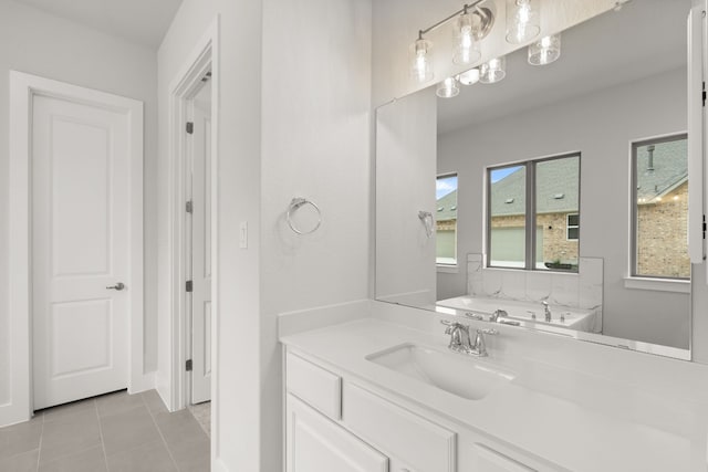 bathroom featuring vanity, tile patterned floors, and a tub