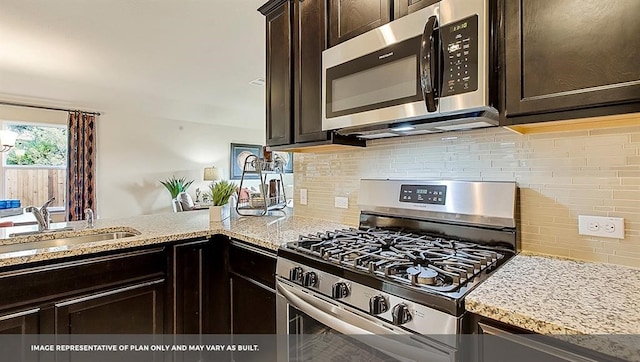 kitchen featuring dark brown cabinets, stainless steel appliances, and sink