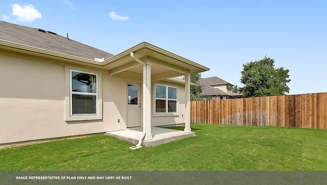 rear view of property with a yard and a patio area