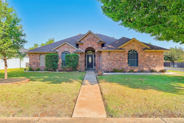 ranch-style home featuring a front yard