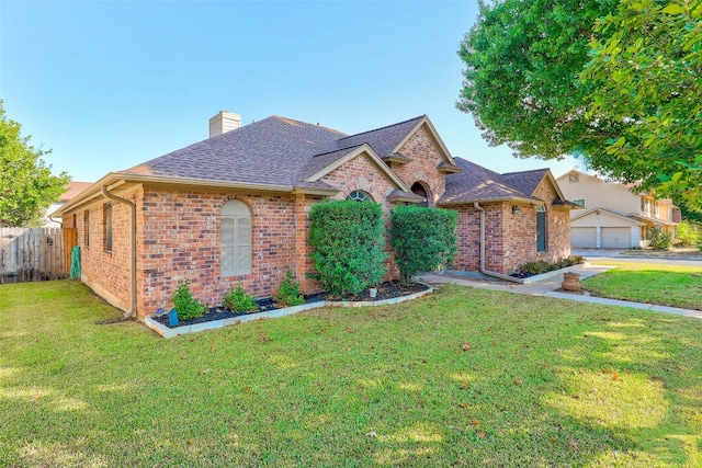 view of front of property with a front yard and a garage