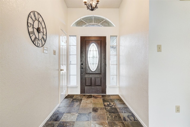 entryway featuring a chandelier and a wealth of natural light