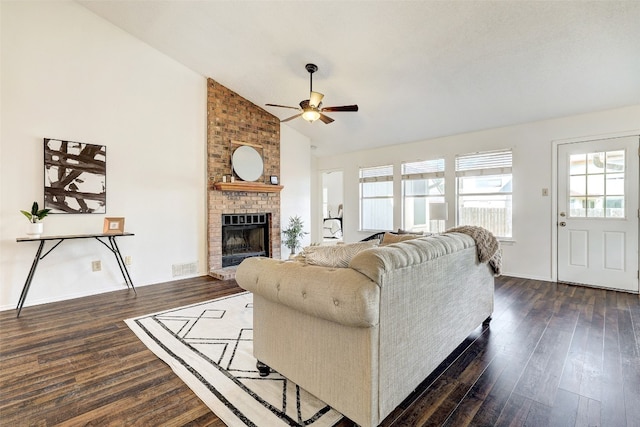 living room featuring high vaulted ceiling, ceiling fan, a fireplace, and dark hardwood / wood-style flooring