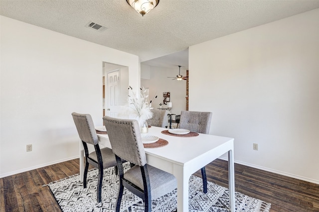 dining space featuring a textured ceiling, dark hardwood / wood-style flooring, and ceiling fan