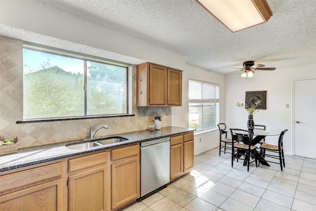 kitchen with tasteful backsplash, light tile patterned floors, ceiling fan, stainless steel dishwasher, and sink