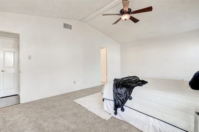 carpeted bedroom with lofted ceiling with beams and ceiling fan