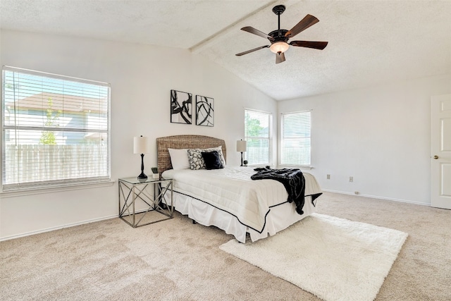 bedroom featuring vaulted ceiling with beams, carpet, a textured ceiling, and ceiling fan