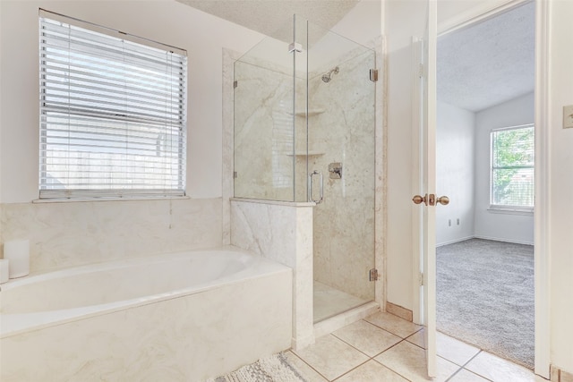 bathroom with tile patterned flooring, a textured ceiling, and independent shower and bath