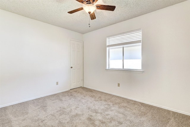 unfurnished room with a textured ceiling, light colored carpet, and ceiling fan