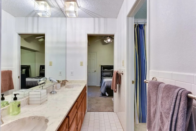 bathroom with vanity, a textured ceiling, tile patterned flooring, and ceiling fan