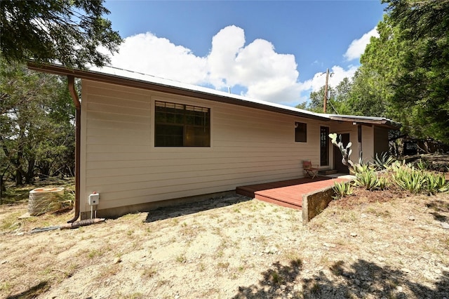 rear view of house featuring cooling unit