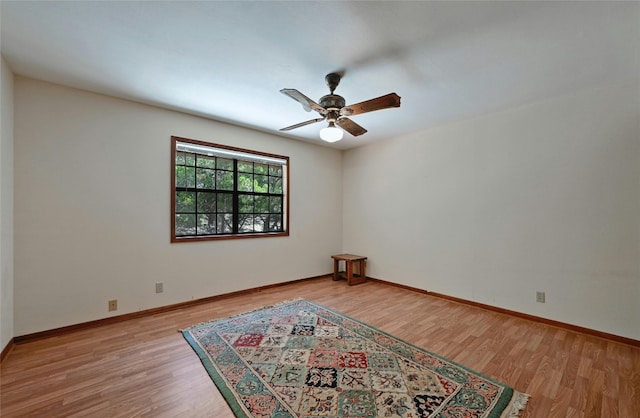 empty room with light hardwood / wood-style floors and ceiling fan