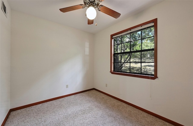 spare room featuring ceiling fan and carpet floors