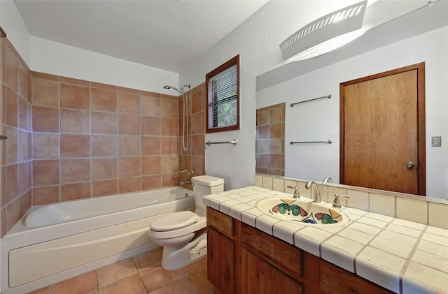 full bathroom featuring tiled shower / bath combo, vanity, toilet, and tile patterned floors