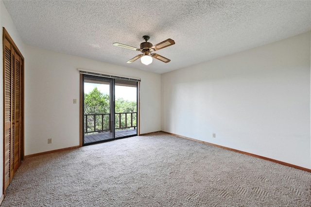 empty room with ceiling fan, a textured ceiling, and carpet flooring