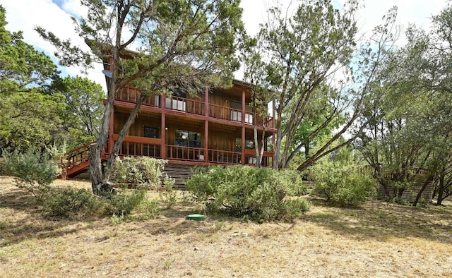 rear view of property featuring a balcony