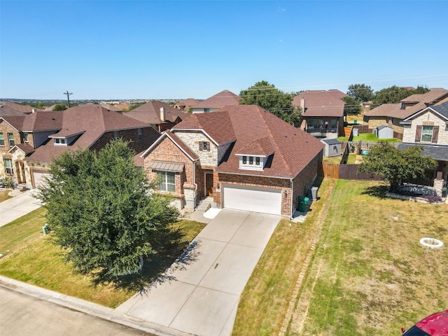 view of front of house featuring a front lawn and a garage