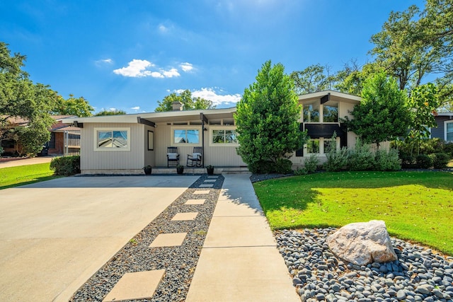 view of front of property with a front yard and a carport