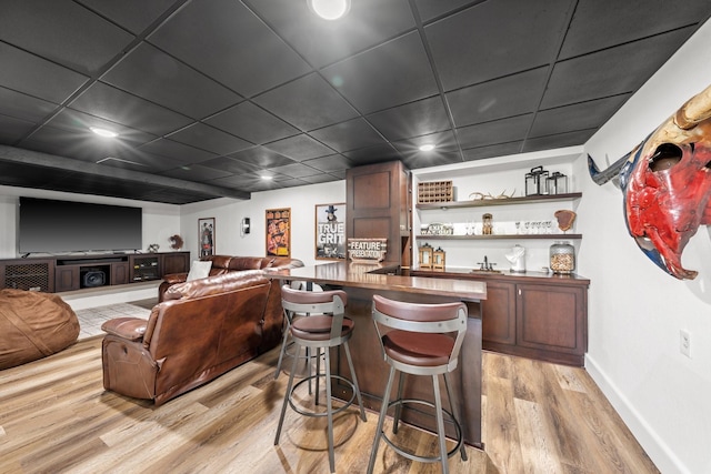 bar featuring light hardwood / wood-style flooring