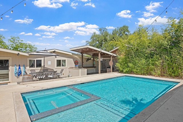 view of swimming pool featuring area for grilling and a patio