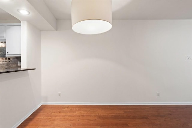 unfurnished dining area with wood-type flooring