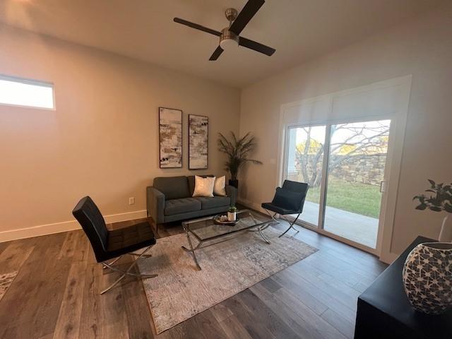 living area with hardwood / wood-style floors, ceiling fan, and a wealth of natural light