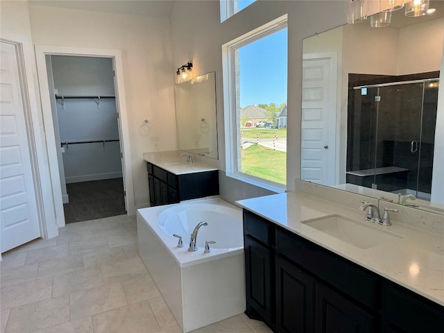 bathroom featuring vanity and independent shower and bath