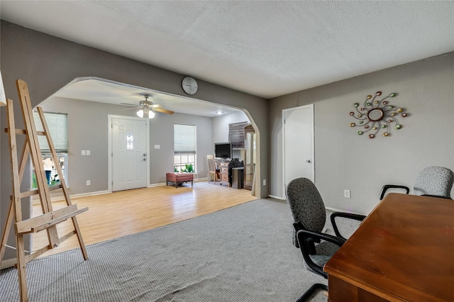 office area featuring ceiling fan, a textured ceiling, and light wood-type flooring