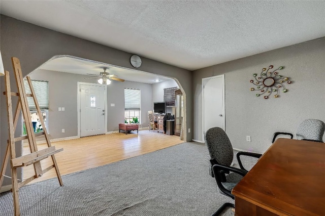 1807 Briar Hill Dr Unit A & B, Austin, TX 78741 - carpeted office space featuring arched walkways, a textured ceiling, a ceiling fan, wood finished floors, and baseboards