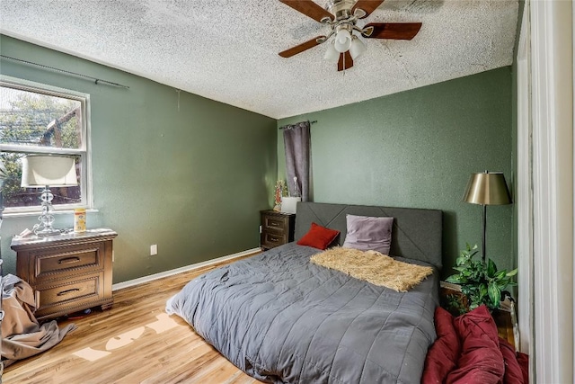 1807 Briar Hill Dr Unit A & B, Austin, TX 78741 - bedroom with a textured ceiling, wood finished floors, a textured wall, and ceiling fan