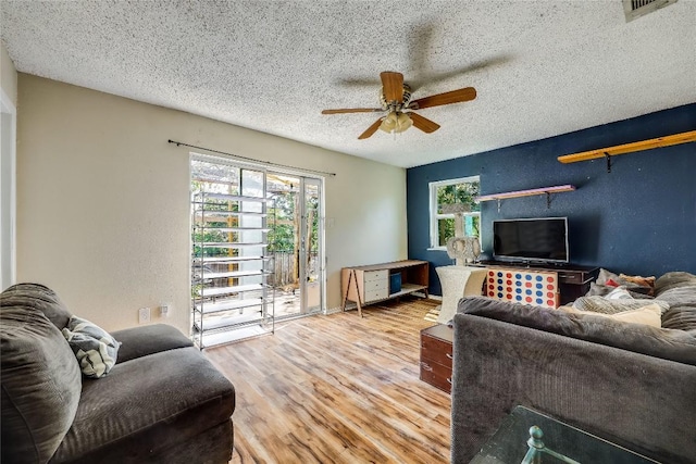 1807 Briar Hill Dr Unit A & B, Austin, TX 78741 - living room featuring a ceiling fan, a textured ceiling, and wood finished floors