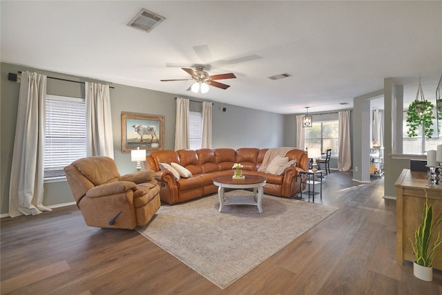 living room with ceiling fan and dark hardwood / wood-style floors