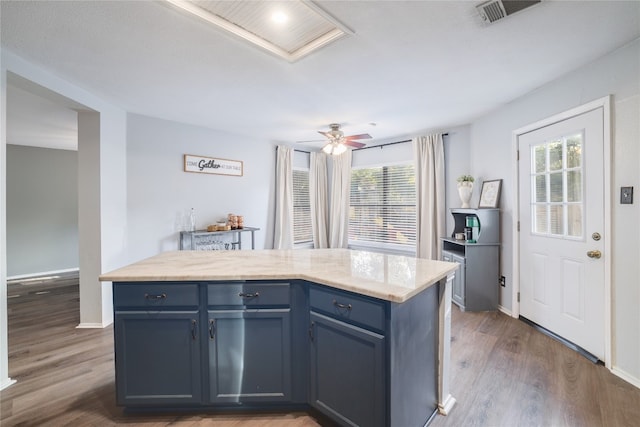 kitchen featuring a center island, dark hardwood / wood-style flooring, and blue cabinets