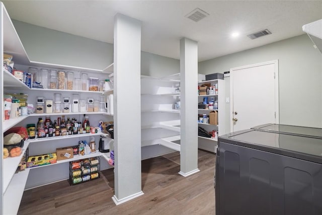 storage area with washer / clothes dryer and visible vents