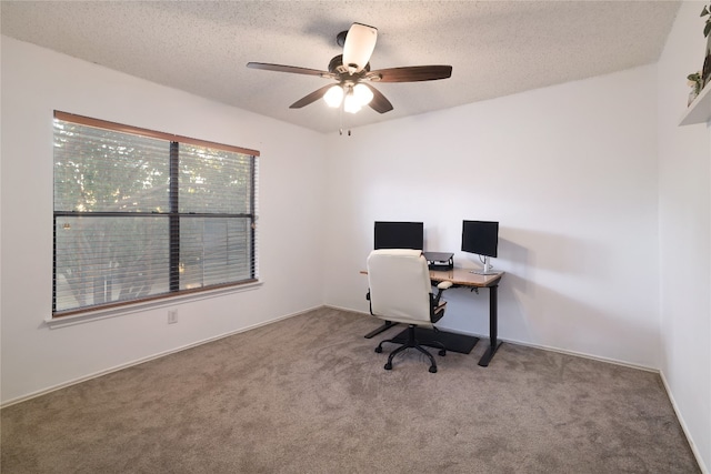 carpeted office featuring a textured ceiling and ceiling fan