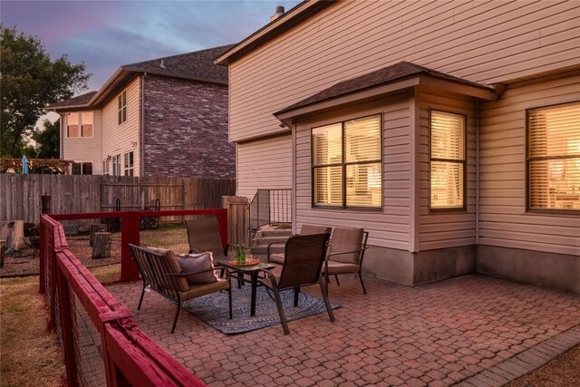 view of patio terrace at dusk