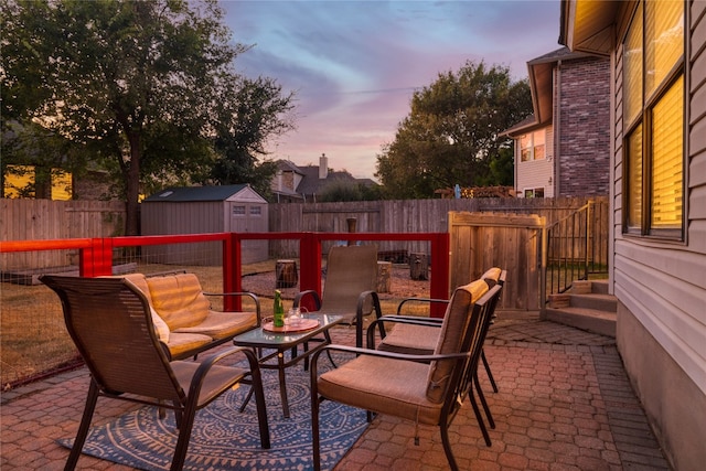 patio terrace at dusk with a shed