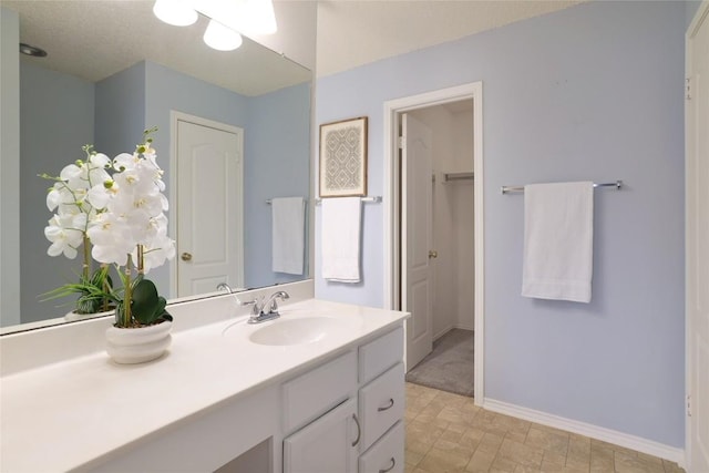 bathroom with baseboards and vanity