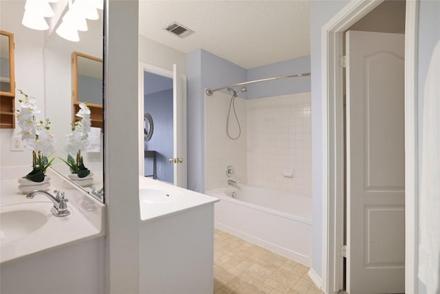 full bath featuring visible vents, shower / tub combination, vanity, and a textured ceiling