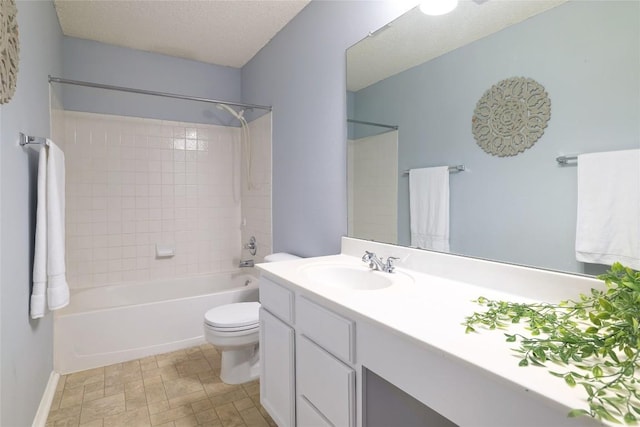 bathroom with baseboards, toilet, a textured ceiling, vanity, and washtub / shower combination